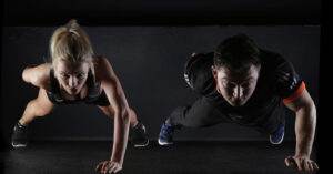 Man And Woman Exercising Home Workout