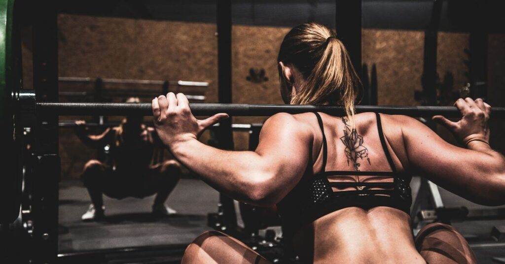 Toned Woman Performing Barbell Squats